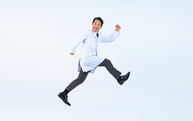 ジャンプする白衣を着た中年男性　医師　科学者（切り抜き背景透過PNGも販売しております。作成者リンクから「PNG」で検索してください）