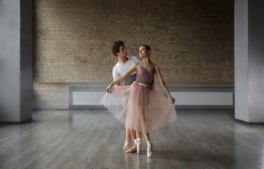 Beautiful young ballet dancers performing choreographic art