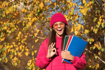 back to school. school education of teen girl. knowledge day on september. autumn september is schooling time. september 1. teen girl with school homework. teen girl enjoy fall outdoor. ok