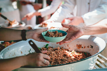 The hands of beggars receive donated food : concept of charity food for the poor