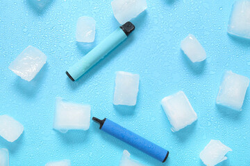 Electronic cigarettes and ice cubes on blue background