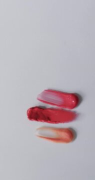 Vertical video of lipstick smudges with copy space on white background