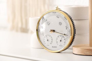 Aneroid barometer on table in room, closeup