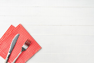 Red paper napkins on white wooden background