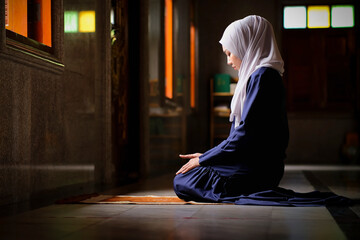 Happy Muslim woman praying for peace from Allah, Muslim God, at room near window Muslim woman's...