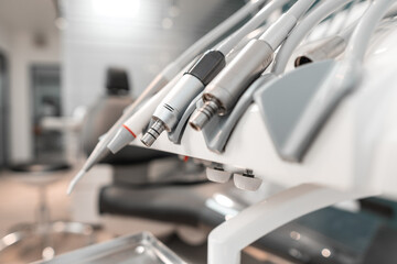 Close-up of dentist's instruments on a professionally equipped treatment chair in a modern dental center. Tools and equipment for dental treatment.