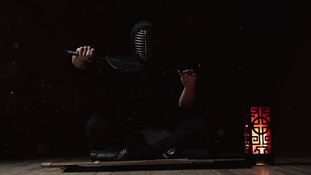 Kendo Master Holding A Katana Amidst Fiery Sparks