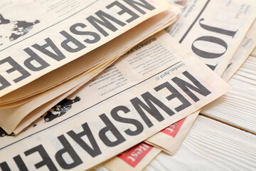 Fototapeta premium Morning newspapers on white wooden background