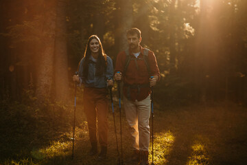 Pair of nature lovers with backpacks on a hiking adventure