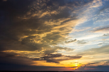 Naklejka na ściany i meble sunset sky with multicolor clouds. Dramatic twilight sky background