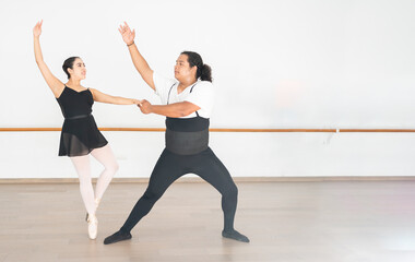 Fototapeta premium ballet dancer couple practicing in a dance studio, hispanic ballerina performing classical ballet with an african american male dancer
