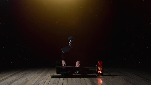 Man In Kendogu Sitting While Unsheathing Katana