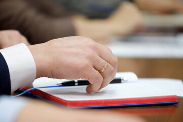 person writing on a notebook