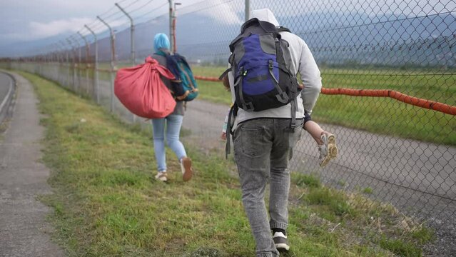 problem an illegal immigrant or an undocumented person a refugee family is running along the fence