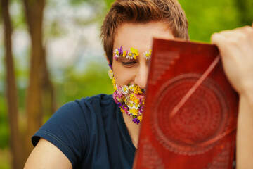 Man's beard blooms, reading ancient leather book