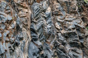 natural stone background texture. rock formation, unusual mountain topography, geological backdrop. Basalt columns formation