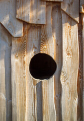 Pine wood construction with a central hole for animal access
