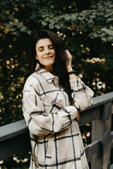 Fototapeta premium A woman rests and meditates in a house in the forest. Retreat and meditation concept