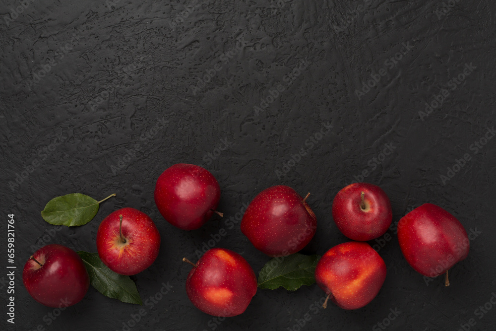 Wall mural fresh red apples with leaves on concrete background, top view