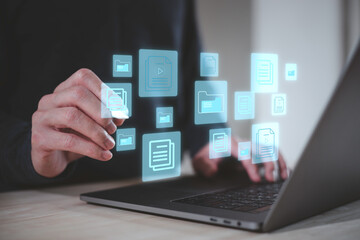 Fototapeta premium Document management system Businessman working on laptop computer productivity checklist and filling survey form online.checklist and clipboard task management.
