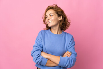 Fototapeta premium Young Georgian woman isolated on pink background happy and smiling