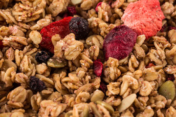 Muesli oat cereals close up background with dry fruits
