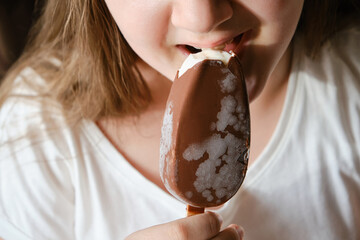 Kid girl eating chocolate ice cream bar