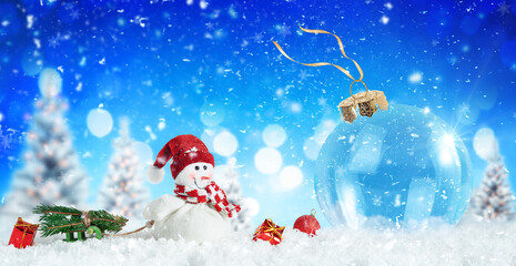 Blue Christmas background with snowman and ornaments on the snow.