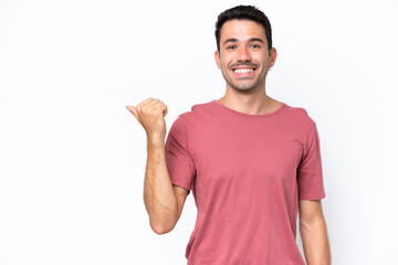 Young handsome man over isolated white background pointing to the side to present a product