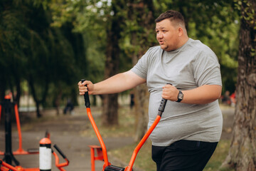 Fat man slowly running outdoors, active lifestyle as struggle with obesity
