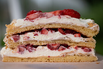 Closeup of Finnish layered cake Brita with fresh strawberries and whipped cream