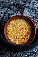 Baked polenta with butter, egg, cheese and bacon, a staple of Romanian cuisine