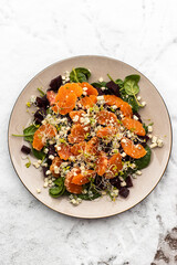 Salad with fresh clementines, steamed beetroot, fresh spinach and blue cheese