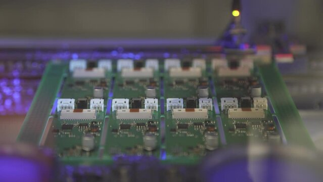 PCB enters the conveyor for application of protective varnish. Automatic PCB coating.