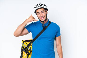 Young caucasian man with thermal backpack isolated on white background making phone gesture. Call me back sign