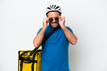 Middle age caucasian man with thermal backpack isolated on white background with glasses and surprised