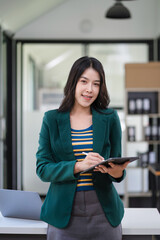 Smiling confident mature business woman leader looking at camera in office.