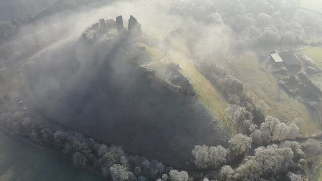 Aerial of Corfe Castle at dawn on a chilly frosty winter morning, Corfe, Dorset, England