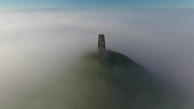 Aerial of Glastonbury Tor on a misty winter morning, Glastonbury, Somerset, England