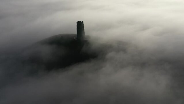 Aerial of Glastonbury Tor on a misty winter morning, Glastonbury, Somerset, England