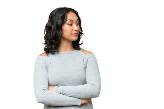 Young Argentinian woman over isolated background looking to the side