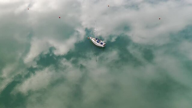 Aerial of a boat moored on the Kingsbridge Estuary near Salcombe, South Hams, Devon, England