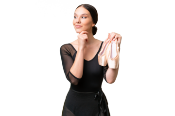 Young caucasian woman practicing ballet over isolated background having doubts