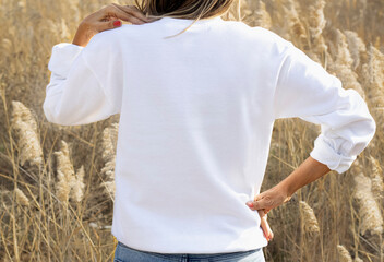 Girl in template blank back white sweatshirt on autumn outdoor design. White hoodie 18000 model...