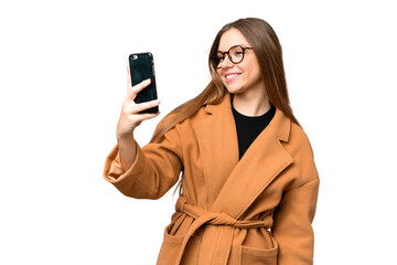 Young blonde woman over isolated chroma key background making a selfie