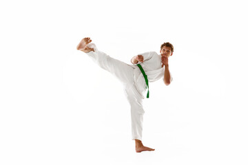 Combat sport athlete, young man in white kimono, practicing karate isolated on white studio background. Concept of martial arts, combat sport, energy, strength, health. Ad © master1305