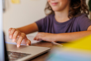 Fototapeta premium child at school. the child uses a laptop for learning. training using modern technologies.