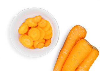 Closeup of whole and cut carrots on white background