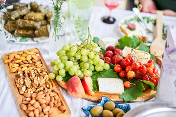 A covered buffet table for a master class. Cheeses, fruits and nuts. Master class and cheese tasting