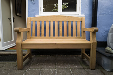 Large, solid wood bench seen at the rear of a terraced house in central London. The back door leads to the kitchen.